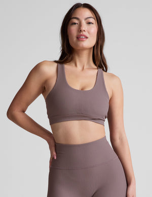 brown medium support racerback bra with a scoop neckline​, overlapping hemband detail​, is lined with performance lining and powermesh in between​, and has removable bra pads​. 