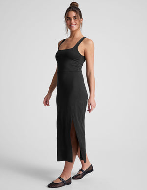 black midi dress with a square neckline and side slit. 