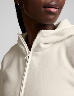 white fleece quarter zip jacket with a kangaroo pocket. 