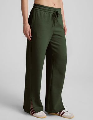 green mid-rise wide leg sweatpants with side slits and a drawcord at waistband. 