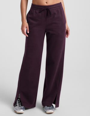 purple fleece wide leg pants with slits on side and a drawcord at waistband on a white background. 