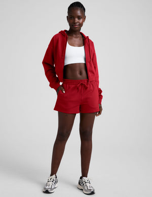 red fleece zip-up jacket with a drawstring hood. 