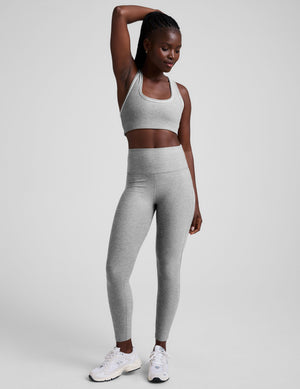 grey high-waisted midi length leggings with white piping details on sides. 