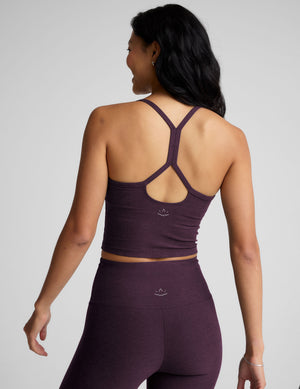 purple slim racerback cropped tank top and purple leggings on a plain background. 